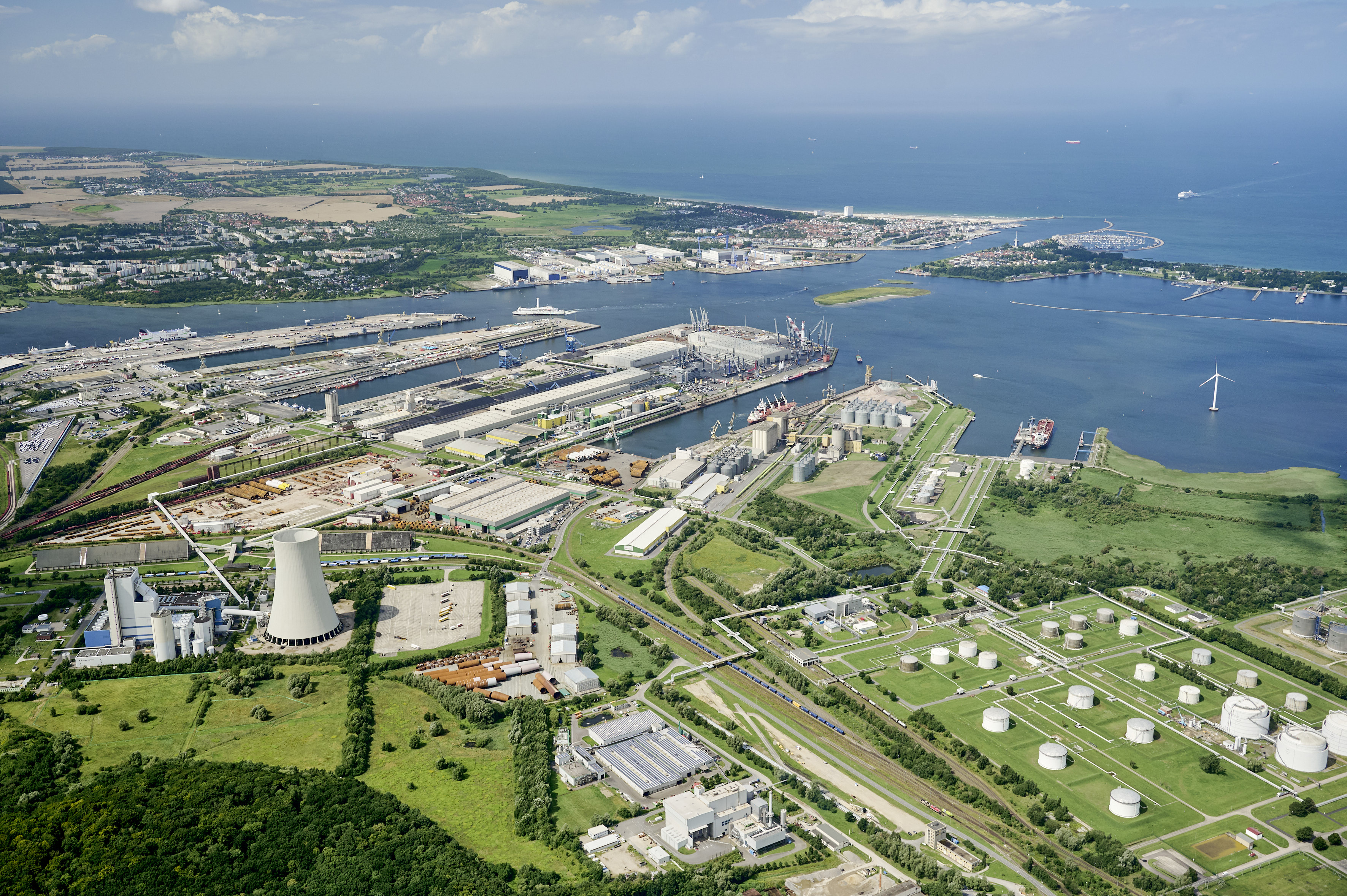 Aerial view of the Port of Rostock with quays, industrial and logistics areas, and ships in the harbor basin. Aerial view of the Port of Rostock with quays, industrial and logistics areas, and ships in the harbor basin.
